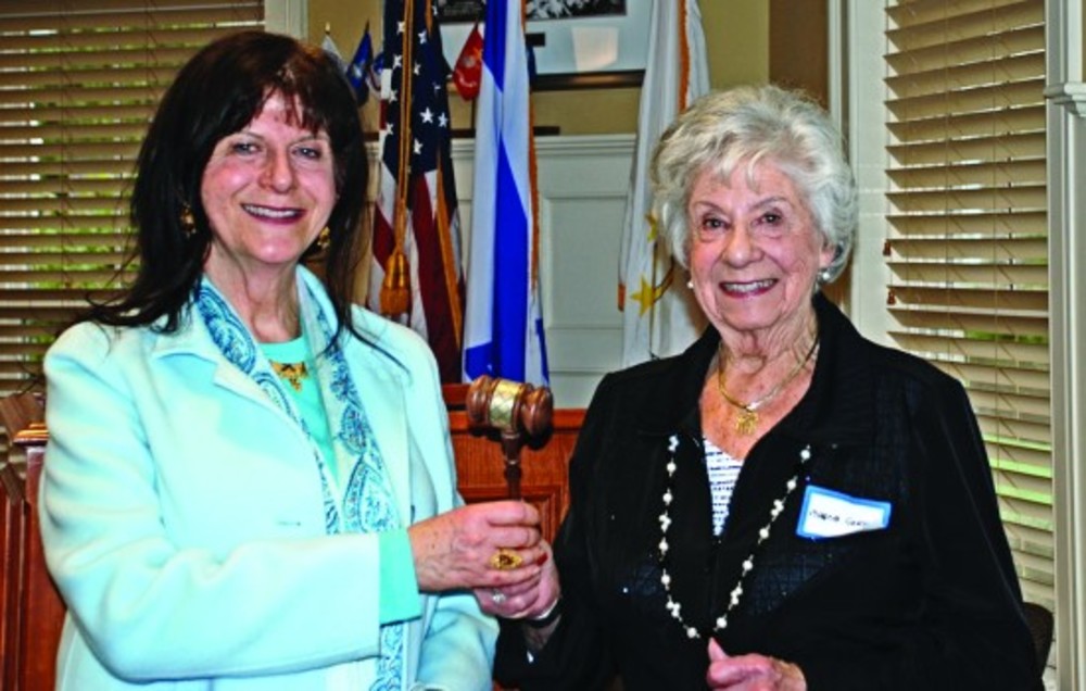 Outgoing Co-President Marcia Gerstein passes the gavel to incoming President Bernice Weiner. /JSA